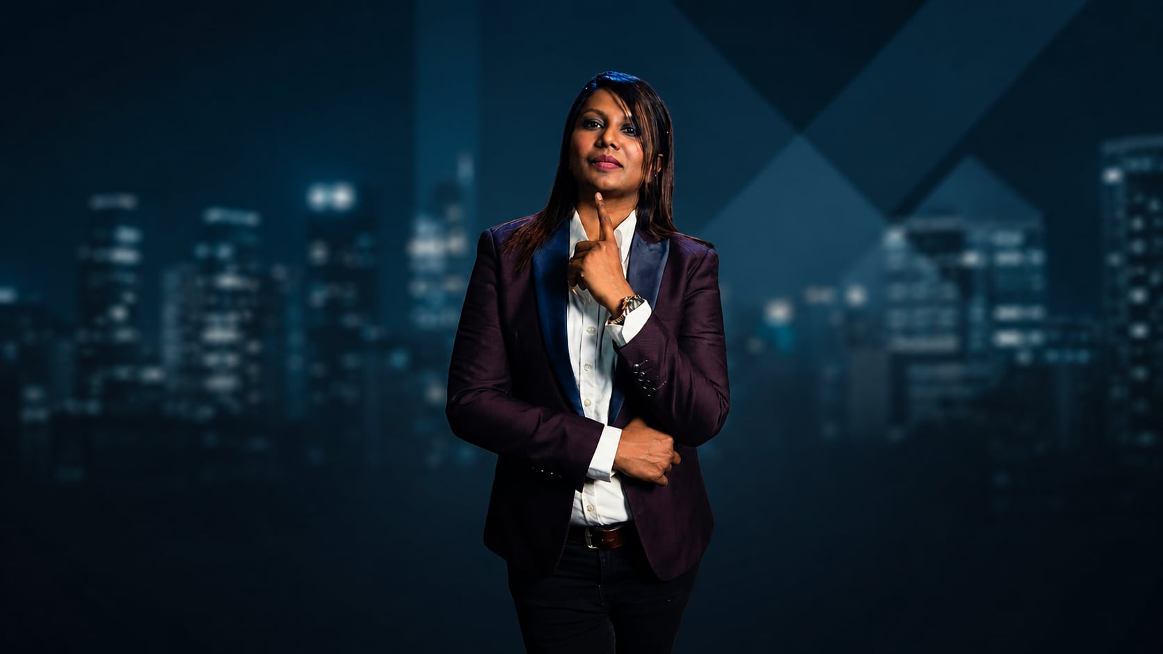 Jazz James standing against a deep blue city backdrop.